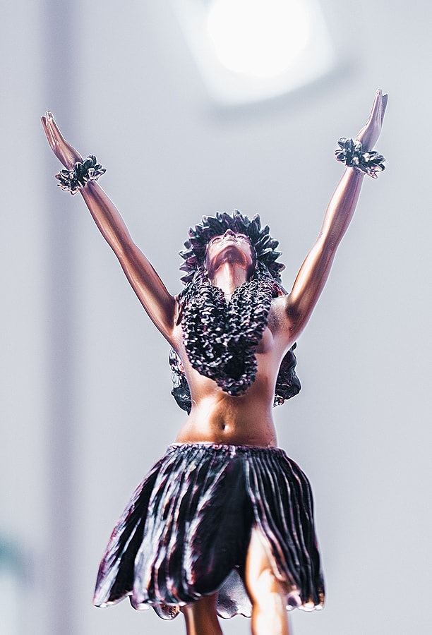 Dancer figurine with arms raised joyfully.