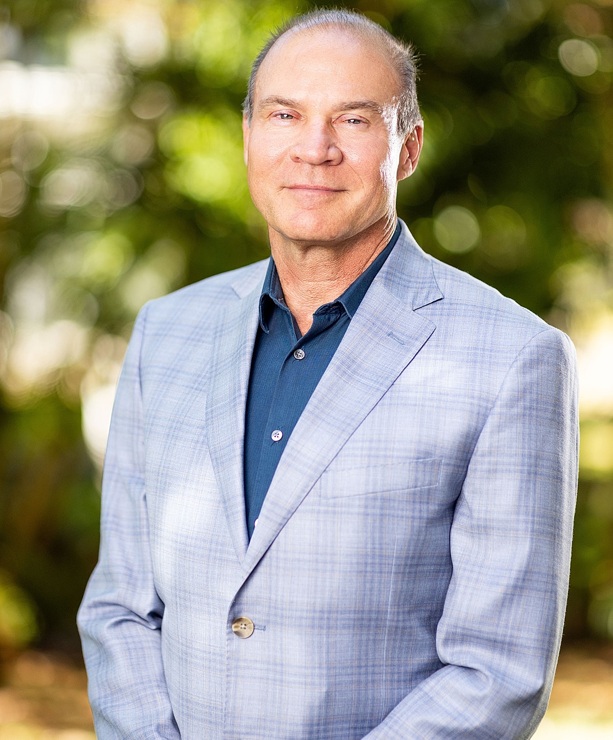 Woman smiling in sunset by the beach.