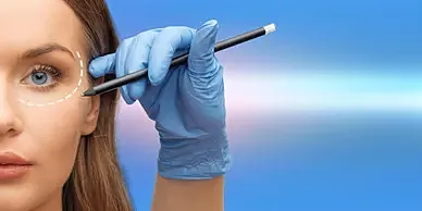 Hand drawing cosmetic procedure on woman's face.