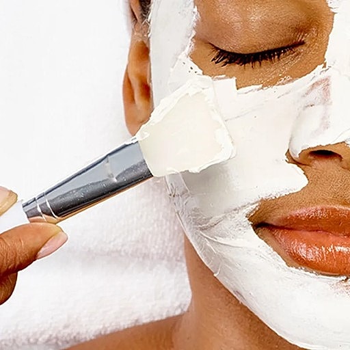 Applying face mask during a skincare treatment.